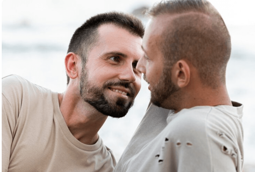 Man smiling confidently at a beach