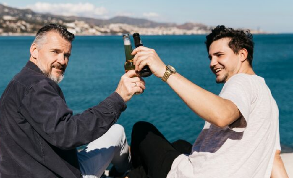 Gay couple holding hands walking in a park